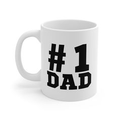 a white coffee mug with the number one dad written in black on it, sitting against a white background