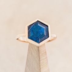 a gold ring with a blue stone in it