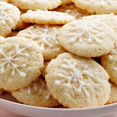 a white plate filled with cookies covered in frosting