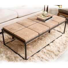 a coffee table sitting on top of a white rug