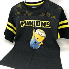 This Crew Neck Black Football Style T Shirt Has Yellow Stripes On The Arms And Bob Hanging From The Minions Word Across The Chest. Across The Top Of The Shirt Is A Mesh Look Alike With The Yellow/Black Colors. Body Is 60% Cotton/40%Polyester. The Mesh Is 100% Polyester. Machine Wash Cold With Like Colors. Non-Chlorine Bleach When Needed. Tumble Dry Low. Do Not Iron Decoration. Boys Size 2xl (18). Soft, Comfortable And Stylish. Black Fun Fan Merchandise Top, Comic Clothes, Florida Shirt, Boys Football, Despicable Me Minions, The Minions, Zara Boys, Boys Stripes, Iron Decoration