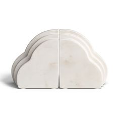 two white cloud shaped vases sitting side by side on top of each other in front of a white background