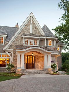 a large brick and stone house with white trim