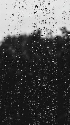 black and white photo of rain drops on window