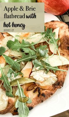 an apple and brie flatbread with hot honey on a plate next to apples