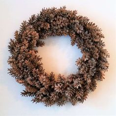 a wreath made out of pine cones on a wall