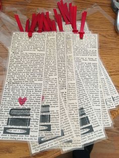 several pieces of newspaper taped to each other with red tape and scissors on top of them