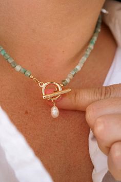 Our Malia Gemstone Toggle Necklace is the ultimate beachy beaded choker! With stunning genuine gemstone options including sunstone, amazonite, labradorite, and apatite, this boho necklace is sure to become a staple for your next adventure. The necklace features a toggle clasp and freshwater pearl accent that will add a touch of elegance to your look and will pair perfectly with any outfit! Gemstone Beaded Jewelry, Necklace Design Ideas, Lady Accessories, Single Pearl Necklace, Wire Jewellery, Amazonite Necklace, Freshwater Pearl Jewelry, Toggle Necklace, Labradorite Necklaces