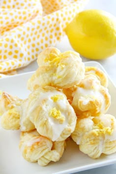 lemon meringue cookies on a white plate next to a lemon and polka dot napkin