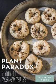 a pan filled with mini bagels covered in sprinkles on top of a table