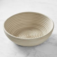 a white bowl sitting on top of a marble counter