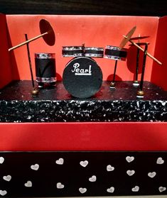 a set of musical instruments sitting on top of a black and white box with hearts