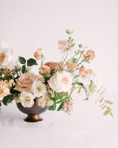 a vase filled with lots of flowers on top of a table