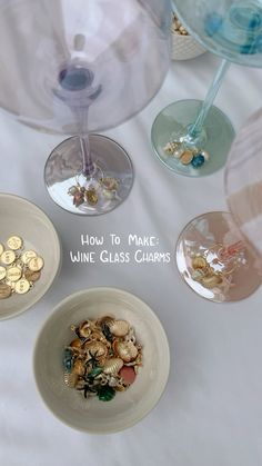 three wine glass charms sitting on top of a table next to some wine glasses with the words how to make wine glass charms