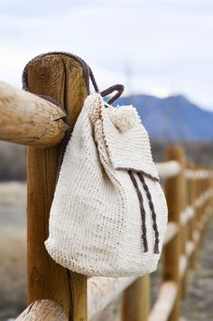 a white bag hanging on the side of a wooden fence