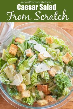 caesar salad in a glass bowl with croutons and parmesan cheese