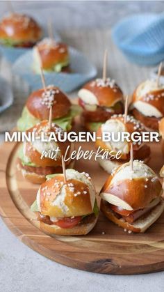 mini burgers with cheese and lettuce on a wooden platter