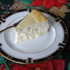 a piece of cake sitting on top of a white and black plate with gold trim