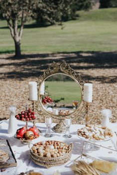 a table topped with pies and desserts under a mirror