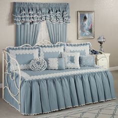 a bedroom with blue bedding and curtains