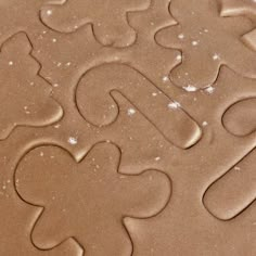 a close up of a puzzle piece in the sand