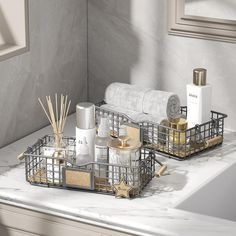 two metal baskets filled with personal care items sit on a marble countertop in a bathroom