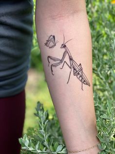 a woman's arm with a tattoo on it that has an image of a praying mantissa