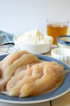 some kind of food on a blue and white plate next to other foodstuffs