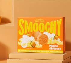 a box of smoochy cookies sitting on top of a table next to a vase