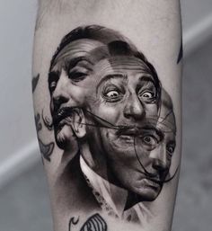 a man's leg with tattoos on it and an image of two faces in the middle