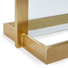 a close up of a mirror with a gold frame and metal handle on the bottom