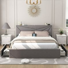 a bedroom with a bed, nightstands and a chandelier on the wall