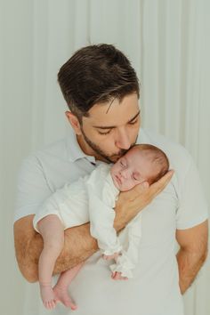 a man holding a baby in his arms