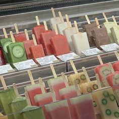 many popsicles are lined up on sticks