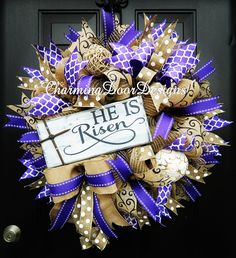 a purple and gold mesh wreath with the words he is risen on it's front door