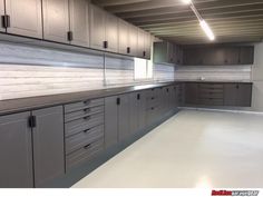 an empty garage with lots of cabinets and drawers