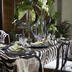 the table is set with zebra print cloths