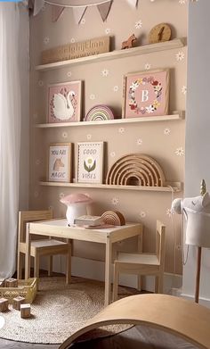 a child's playroom with toys and decor on the wall, including shelves