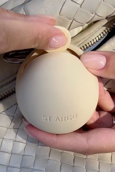 a person holding an item in their hand with the word st argo on it