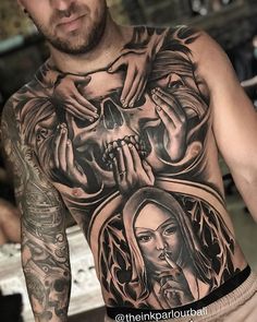 a man with tattoos on his chest and hands holding a skull in front of him