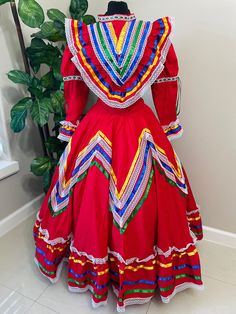 Step into the spotlight with our Beautiful Women's Jalisco Dress, a culturally inspired costume that embodies the spirit of Mexico. Handmade with love and attention to detail, this dress comes with 3 color satin ribbons in yellow, royal blue,  and green to add a pop of color to your ensemble.  Overview: Available in sizes S, M, and L, with bust lines ranging from 34-44" and skirt lengths from 24-34", this dress is a timeless piece for any celebration.  Delivery times: Please allow 2-3 weeks for Multicolor Fiesta Dresses For Festivals, Multicolor Dresses For Fiesta Festivals, Multicolor Dresses For Fiesta And Festivals, Multicolor Carnival Costume Dress, Multicolor Folk Dress For Fiesta, Folk Style Multicolor Dress For Fiesta, Multicolor Folk Style Dress For Fiesta, Traditional Fitted Costume Dress, Traditional Multicolor Fiesta Dress