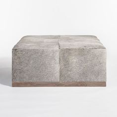 an ottoman made out of concrete blocks on a white surface with wood trimmings