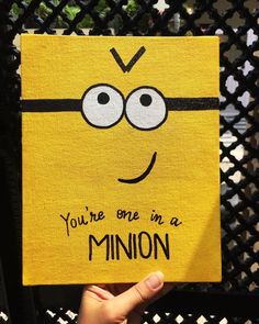 someone holding up a piece of paper with the words you're one in a minion on it