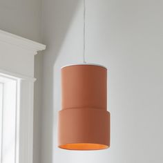 an orange light hanging from a ceiling in a room