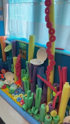 there are many different colored objects in the play area, including plastic letters and numbers