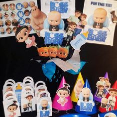 a table topped with cake toppers and party hats next to other birthday decoration items