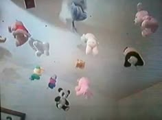 several stuffed animals are hanging from the ceiling