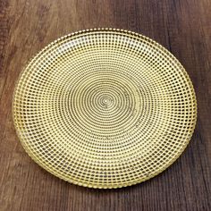 a gold plate sitting on top of a wooden table