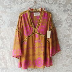 Gorgeous 70's tones adorn this tunic dress. Designed with a mustard base, pink print, v-neck, long fluttering sleeves, and soft fit. One size for small, medium, & large. A one of a kind piece for your wardrobe. Custom made to order. Please allow 2 weeks for production. Color: Mustard & pink 100% Polyester Imported Hand Wash Cold split One size for S,M, & L Bust 37 Waist 38 Hips 39 Length 33 Bust, waist, and hip measurements are a total circumference. Length is measured from the top o 70s Inspired Fashion, Boho Boutique, Boho Girl, Wholesale Dress, 70s Inspired, 70 Dress, Sweet Dress, Inspired Dress, Pink Print