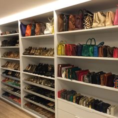 a closet filled with lots of purses and handbags next to a wall mounted shoe rack